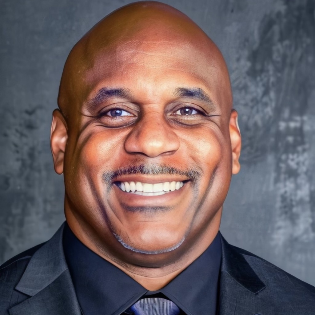 Lew Montgomery in a dark blue suit and tie