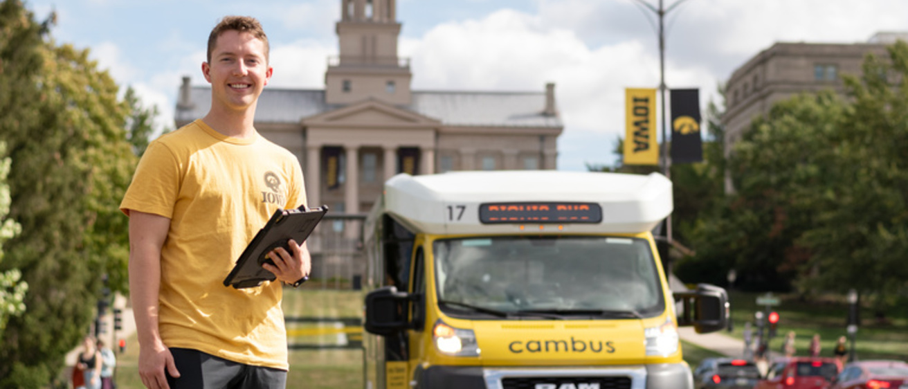 Picture of transit worker and CAMBUS in front of the Old Capital 