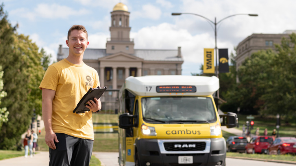 Picture of transit worker and CAMBUS in front of the Old Capital 