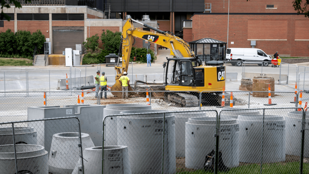Construction workers and crane working on site 